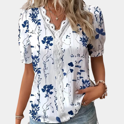 LP | Women's blouse with floral pattern and lace trim.