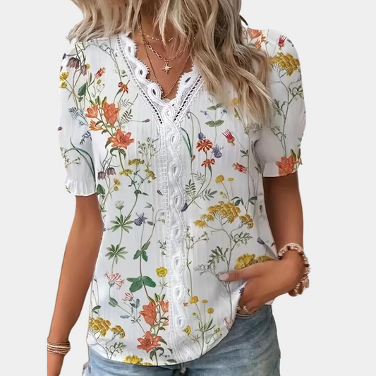 LP | Women's blouse with floral pattern and lace trim.